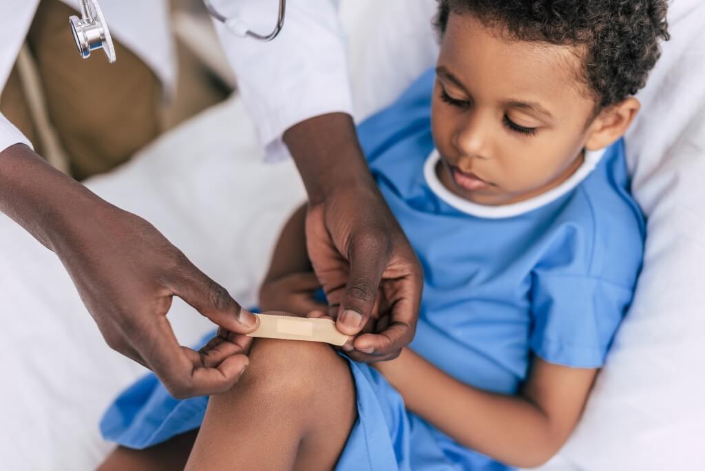 Doctor Putting Aid On A Child
