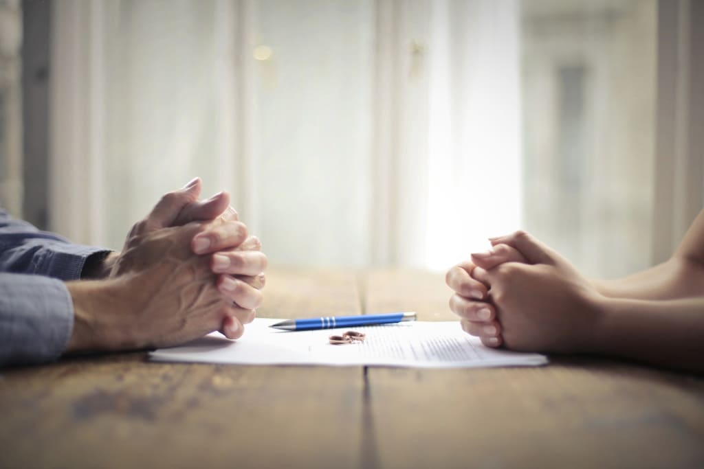 Pen And Ring Lying Over A Legal Doc